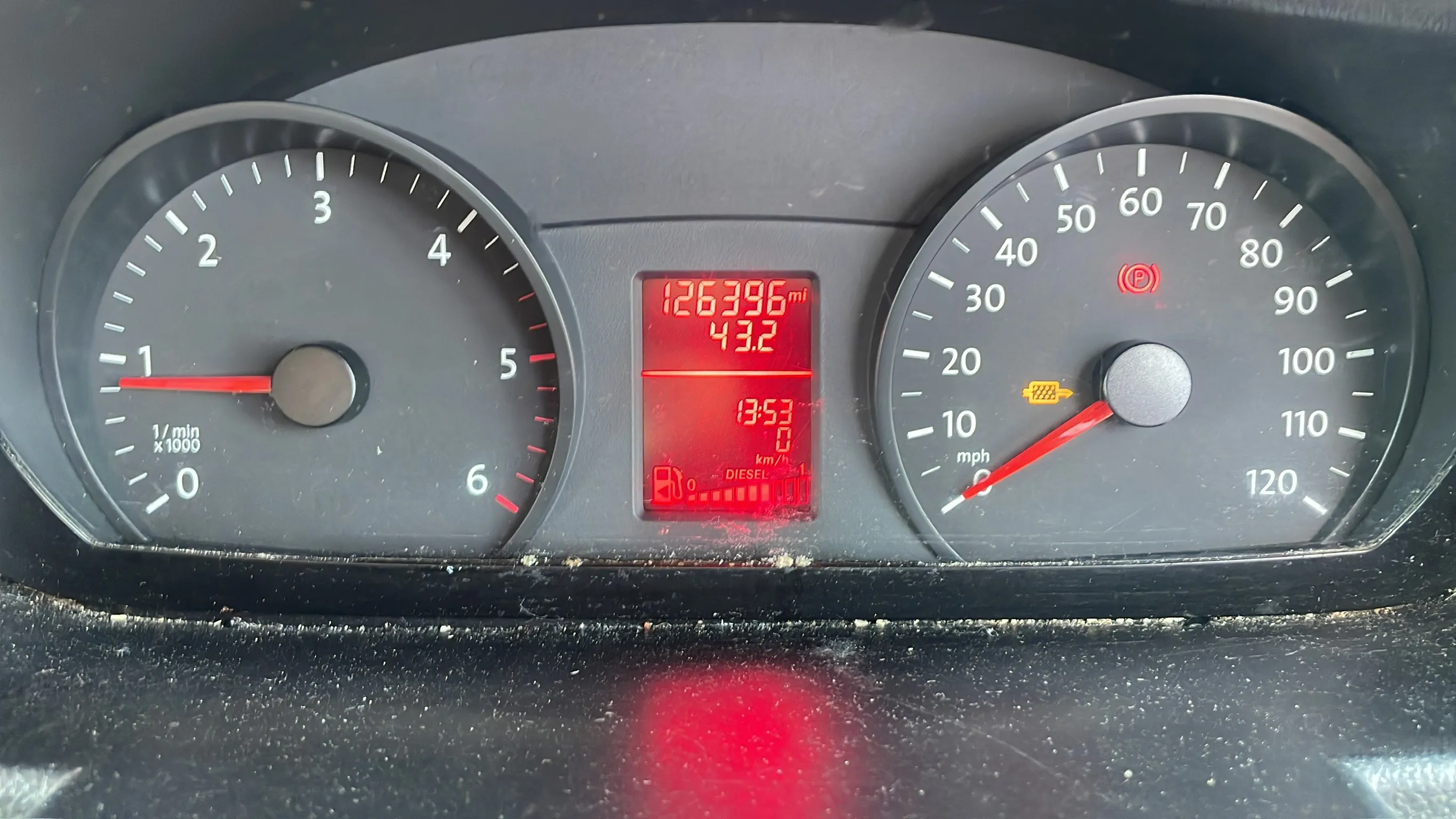 A diesel instrument cluster showing 126,396 miles with the glow plug warning light lit