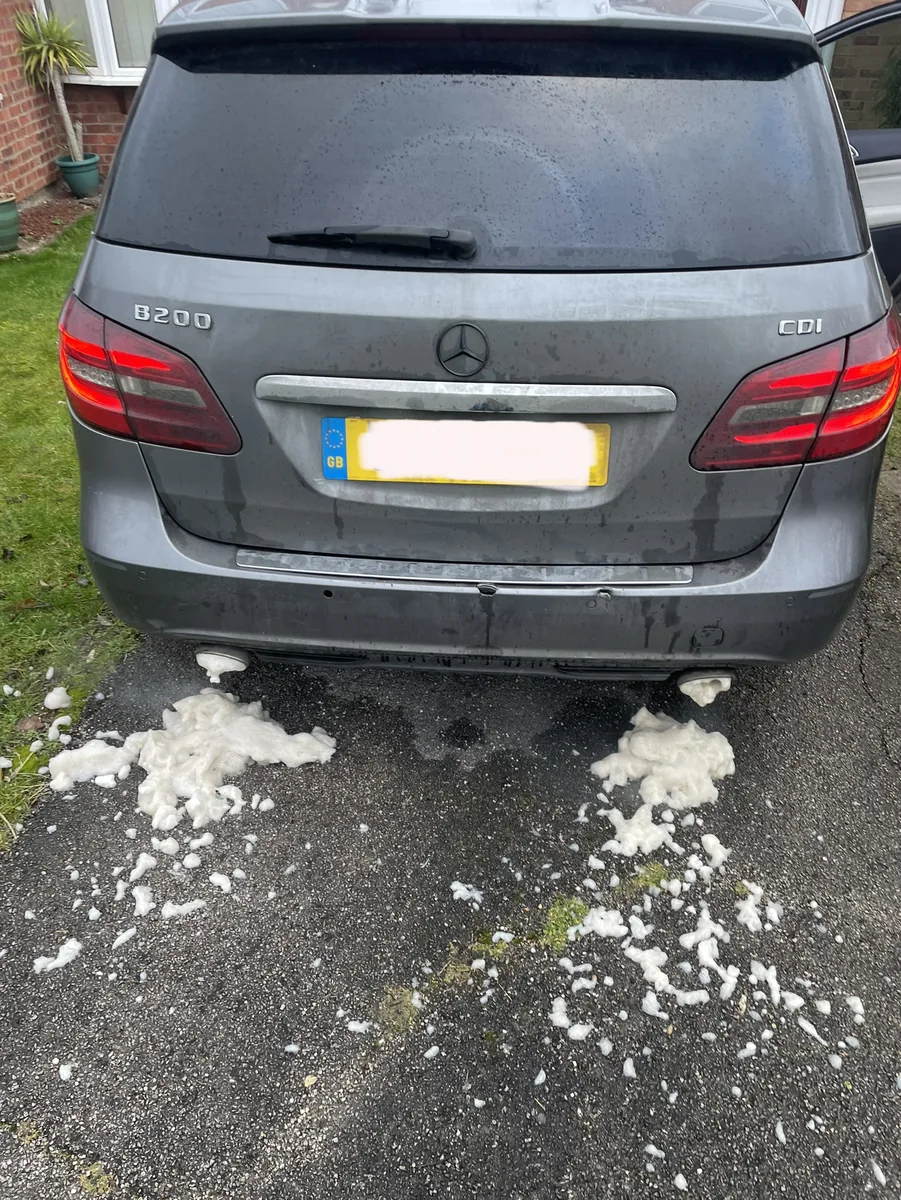 A Mercedes B200 CDI in Cambridge with cleaning foam at both exhaust pipes during a DPF clean