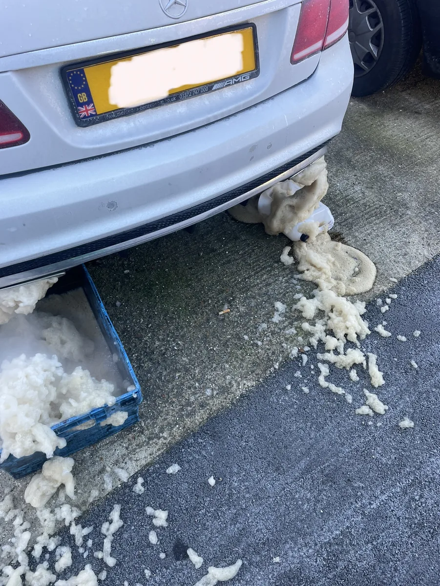 A Mercedes during a mobile DPF clean in Hemel Hempstead, with cleaning foam draining from the exhaust