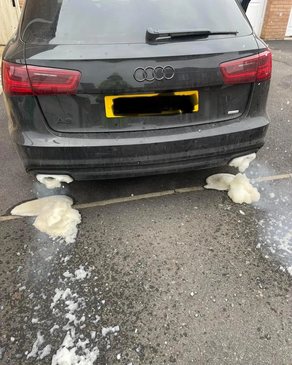 An Audi A6 Avant during a mobile DPF clean in St Albans, with cleaning foam draining from the exhaust